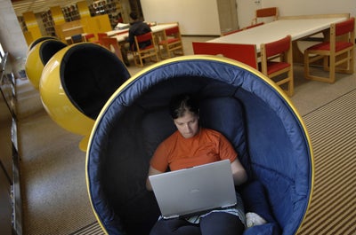 Student with laptop computer in a semi-spherical chair
